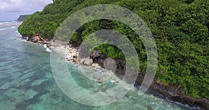 Beautiful tropical island Bali, rocky shore with blue ocean water, aerial shot