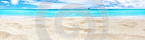 Beautiful tropical island panorama, white sand beach, turquoise sea water, ocean waves, sun blue sky clouds, blurred background