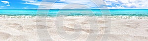 Beautiful tropical island panorama, white sand beach, turquoise sea water, ocean waves, sun blue sky clouds, blurred background