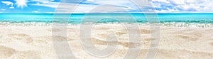 Beautiful tropical island panorama, white sand beach, turquoise sea water, ocean waves, sun blue sky clouds, blurred background
