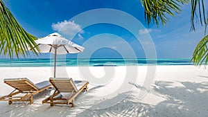 Beautiful tropical island scenery, two sun beds, loungers, umbrella under palm tree. White sand, sea view with horizon