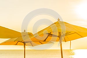 Beautiful tropical nature umbrella chair with palm tree around beach sea ocean at sunset or sunrise