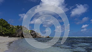 Beautiful tropical sandy beach. Huge boulders with smoothed slopes