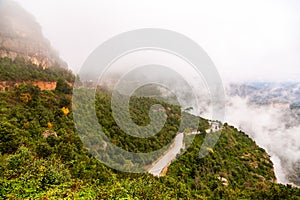 Beautiful tropical scenery of forest road with lost in the fog mountains