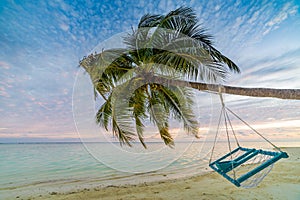 Exotic travel destination, wonderful scenery of tropical beach with two lounge chairs and photo