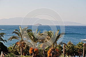 Beautiful tropical sea bay with palms. Scenic landscape with mountain islands and blue lagoon on Aegean sea. Exotic scenery.
