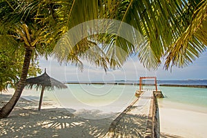 Beautiful tropical sunny beach near the ocean with umbrella and cabana