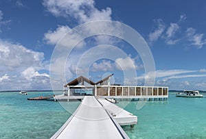 Beautiful tropical vibrant panorama of arrival jetty at the island resort