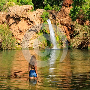 Beautiful tropical waterfall and woman traveling in Portugal