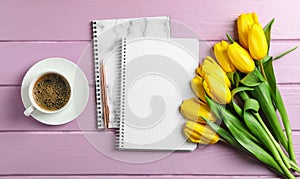 Beautiful tulips, copybooks and cup of coffee