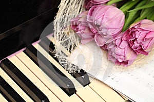 Beautiful tulips flowers on piano keys background