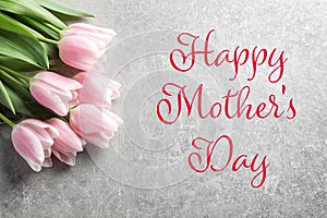 Beautiful tulips for Mother`s Day on grey background