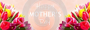 Beautiful tulips and phrase HAPPY MOTHER`S DAY against background. Banner design