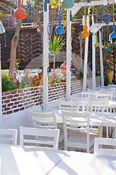 beautiful Turkish style restaurant with white tables and colorful decorations in Kas city