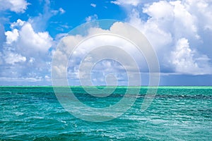 Green ocean water. West Pacific Ocean with white clouds and blue sky. Dark and light green sea water. Yap Island, Micronesia. photo