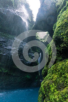 Beautiful turquoise crystal clear water cave with waterfall in the middle of the tropical jungle of Costa Rica