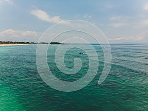 Beautiful turquoise ocean water with boat on it top view aerial photo.