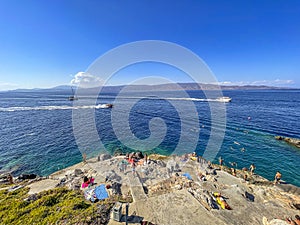 Beautiful turquoise rocky seascape with a famous swimming place full of tourists and visitors near Hydronetta coctail bar in Hydra