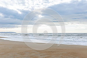 Beautiful turquoise sea with foamy water on the sandy shore. Resort and relaxation on vacation. Space for text. Background. Front