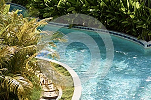 Beautiful turquoise water in the pool surrounded by tropical greenery