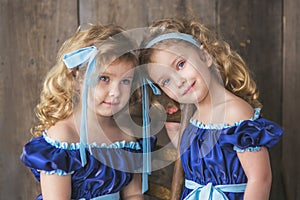 Beautiful twin girls in blue dresses