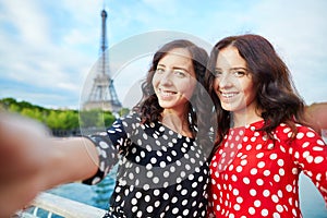 Beautiful twin sisters taking selfie