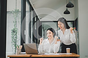 Beautiful two asian girl celebrate with laptop, success happy pose, E-commerce