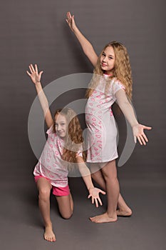 Beautiful two girls in pink pajamas play before going to bed