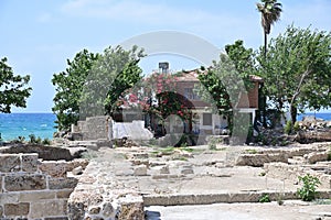 A beautiful two-story red brick mansion with a tiled roof on the seaside