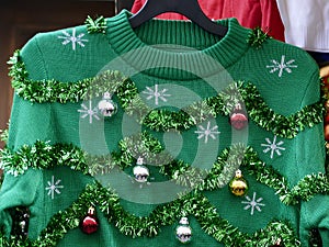 Beautiful or ugly: green Christmas sweater with decor balls