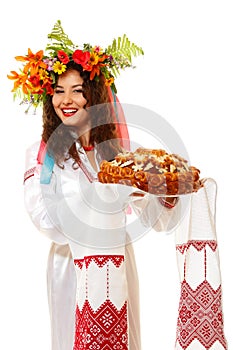 Beautiful ukrainian woman in garland and native costume holding