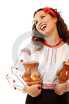 Beautiful ukrainian young woman in native costume holding earthe