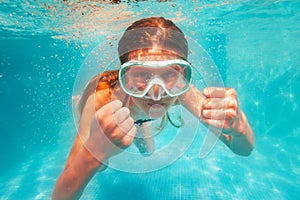 Cute girl in scuba mask swim and pose underwater