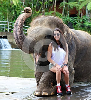 Beautiful unique elephant with girl at an elephants conservation reservation in Bali Indonesia