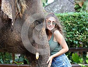 Beautiful unique elephant with girl at an elephants conservation reservation in Bali Indonesia