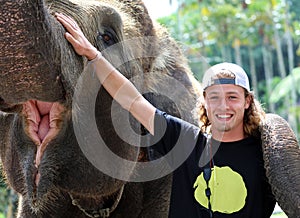Beautiful unique elephant with man tourist at an elephants conservation reservation in Bali Indonesia