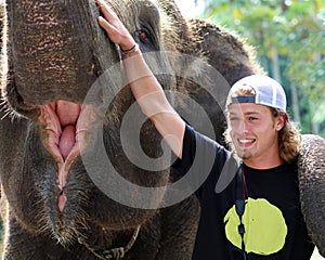 Beautiful unique elephant with man tourist at an elephants conservation reservation in Bali Indonesia