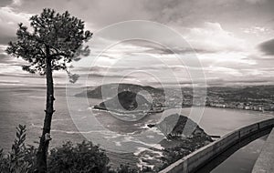 Beautiful upper aerial view on san sebastian coastline from mountain monte igueldo in sunset sky in black and white sepia