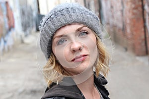 Beautiful urban girl wearing beanie and a popular nose ring