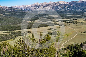 Beautiful valley view of the Frank Church Wilderness in central Idaho. Winding dirt road leads to the mountains