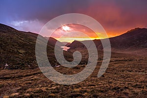 Beautiful valley with water reservoir in Mourne Mountains at golden hour and dramatic sunset