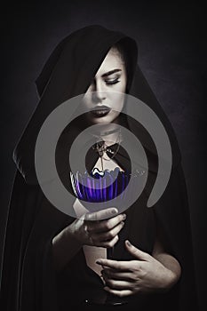 Beautiful vampire with a ritual cup