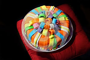 Beautiful varicolored birthday cake with imitation