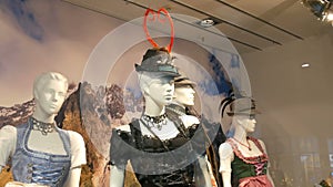 Beautiful various women`s national Bavarian costumes dirndl on shop window