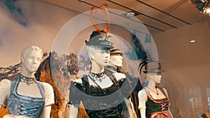 Beautiful various women`s national Bavarian costumes dirndl on shop window