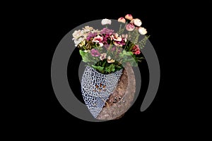 Beautiful Vase with yellow, red, pink, purple plastic flowers and leaves in Solid Black Background