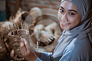 beautiful in veil craftswoman holding woven water hyacinth basket