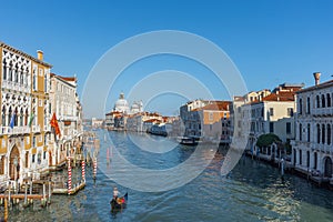 Beautiful Venetian view with Grand Canal, Basilica Santa Maria della Salute and traditional gondolas, in Venice, Italy
