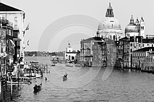 Beautiful Venetian view with Grand Canal, Basilica Santa Maria della Salute and traditional gondolas, in Venice, Italy black and