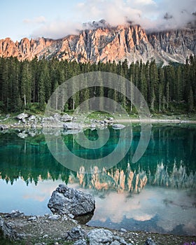 Beautiful vertical shot of the Karersee alpine lake in Welschnofen Italy